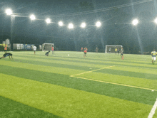 a group of soccer players on a field at night