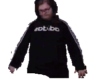 a man wearing a black adidas sweatshirt is standing