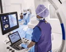 a surgeon is operating on a patient in an operating room while a nurse looks on .