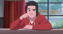 a man in a red hoodie is leaning on a table