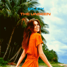 a woman in an orange dress is smiling in front of palm trees and the words enjoy the unseen above her