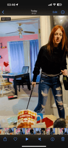 a phone screen shows a woman holding a bottle of champagne and a bag of popcorn