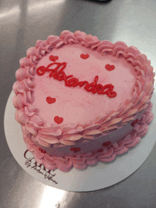 a heart shaped cake with alexandra written on it