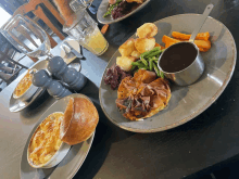 plates of food on a table including potatoes green beans and gravy