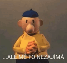 a cartoon character with a blue hat and a yellow shirt is holding his hands together and says `` ale me to nezajima '' .