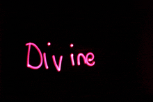 the word divine is written in pink letters on a black background