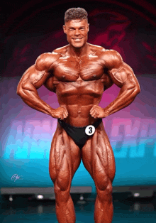 a bodybuilder wearing a number 3 on his waist