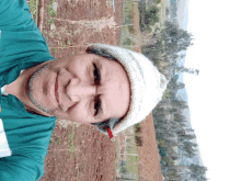 a man wearing a white hat and a green shirt