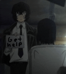 a man in a suit and tie holds a sign that says get help