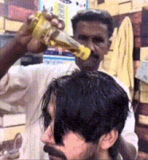 a man is getting his hair cut by a man with a beard