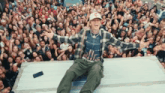 a man wearing a baseball cap with the letter c on it stands in front of a crowd