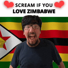a man with glasses screams in front of a zimbabwe flag