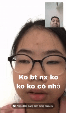 a girl wearing glasses is talking on a video call with a man