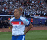 a female soccer player wearing a number 7 jersey