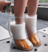 a person is pouring beer into a pair of shoes