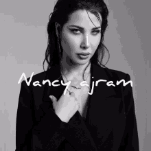 a black and white photo of nancy ajram with a necklace