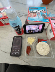 a box of lunchly cereal sits on a table next to a bottle of drink