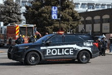 a police car is parked on the side of the road .