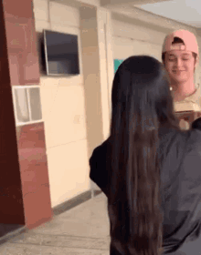 a man wearing a pink hat is talking to a woman