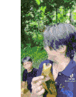 a man with purple hair is eating a banana while a boy watches .