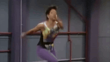 a couple of women are dancing in a dance studio .