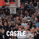 a crowd of people watching a basketball game and the word castle is on the bottom