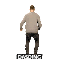 a man in a grey sweater is standing on a sign that says dasding