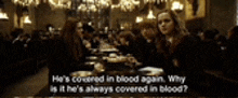 a group of people are sitting at a long table in a room with a blurred background .