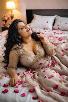 a woman in a dress is laying on a bed covered in petals