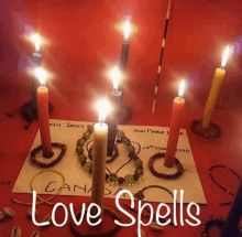 a table with candles and the words love spells written on it