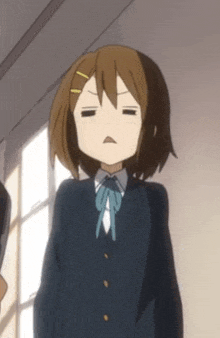 a girl in a school uniform is making a funny face with her eyes closed