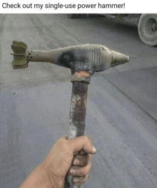 a person is holding a hammer with a bomb on it