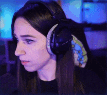 a woman wearing a pair of headphones with a blue background