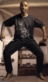 a man wearing a black shirt with a picture of a man on it