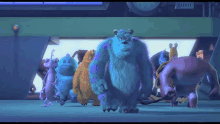 a group of monsters from the movie monsters inc are standing in a room