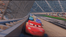 a row of cars are racing on a race track .