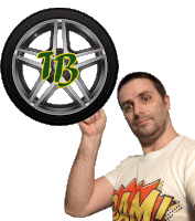 a man is holding up a tire with the letter tb on it