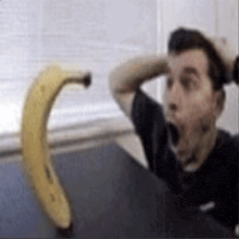 a man yawning in front of a banana