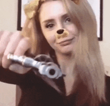 a woman is wearing a lion costume and holding a gun .