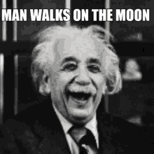 albert einstein is laughing in a black and white photo with the caption " man walks on the moon "