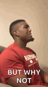 a man in a red shirt is sitting on a couch with his eyes closed and says `` but why not '' .
