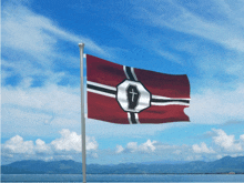 a flag with a coffin and cross on it is flying in the wind