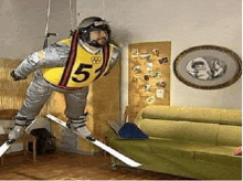 a man in a space suit is flying through the air on skis .