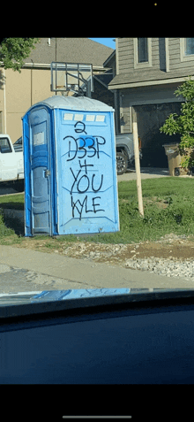 a blue portable toilet with graffiti on it that says " d3p if you kyle "