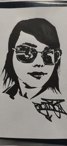 a black and white drawing of a woman wearing sunglasses with graffiti on it