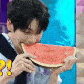 a man is eating a slice of watermelon with an exclamation point on it