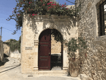 a stone building with a red door and a sign that says ' a few steps away '