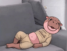 a cartoon hippo is laying on a couch wearing a shirt that says nft moodfg