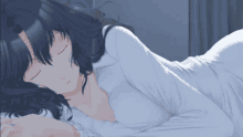 a girl with black hair is sleeping on a bed