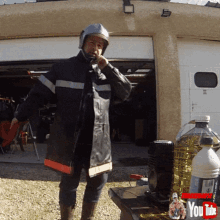 a man wearing a helmet is standing in front of a garage door with a youtube logo in the corner